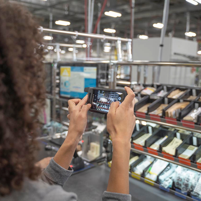 Woman taking a picture with the Motorola Evolve